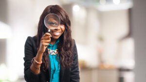 woman looking through magnifying glass